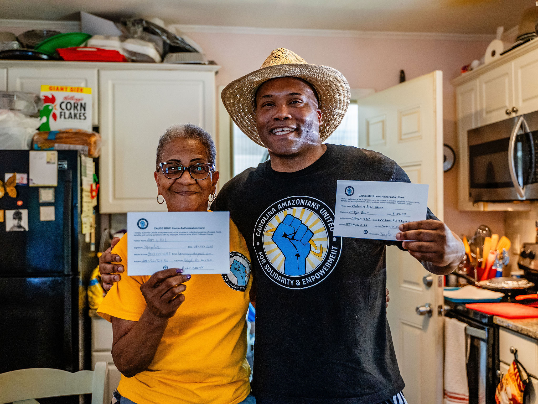 Ryan Brown and Mary Hill signing union cards